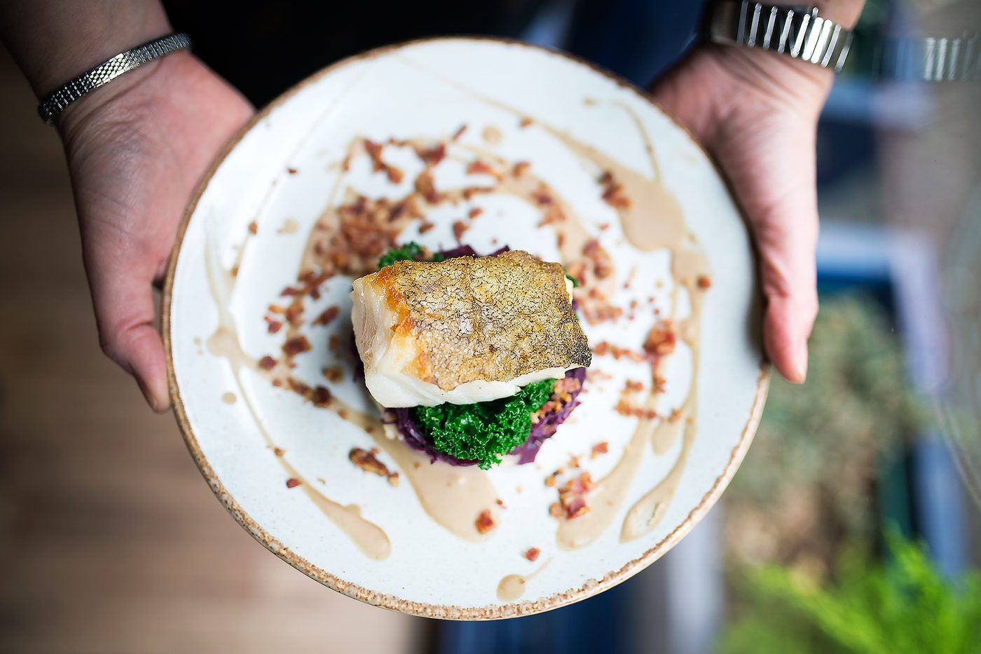 A plate of roasted fish brought from the kitchen