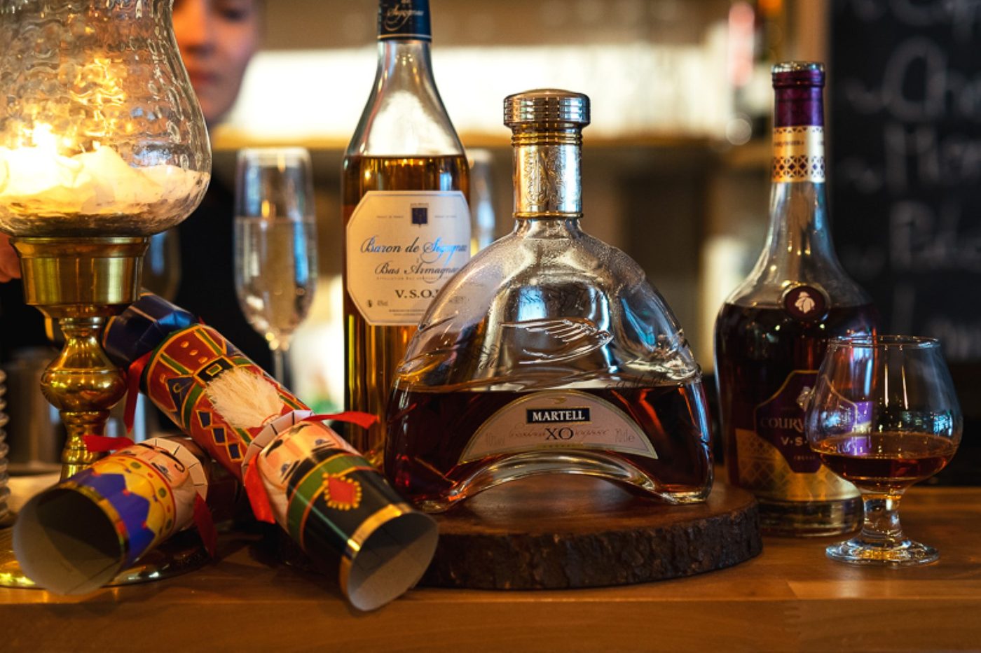 Cognac and armagnac bottles in lamplight at the bar
